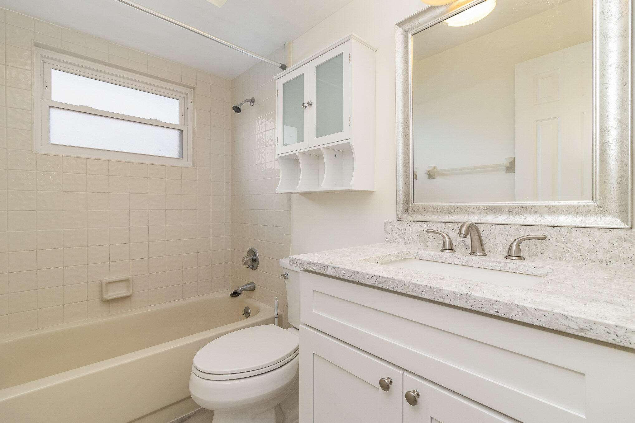 446 Timberlake Drive Melbourne, FL 32940 - Photo 18 of 20 a bathroom with a granite countertop toilet sink and a bathtub