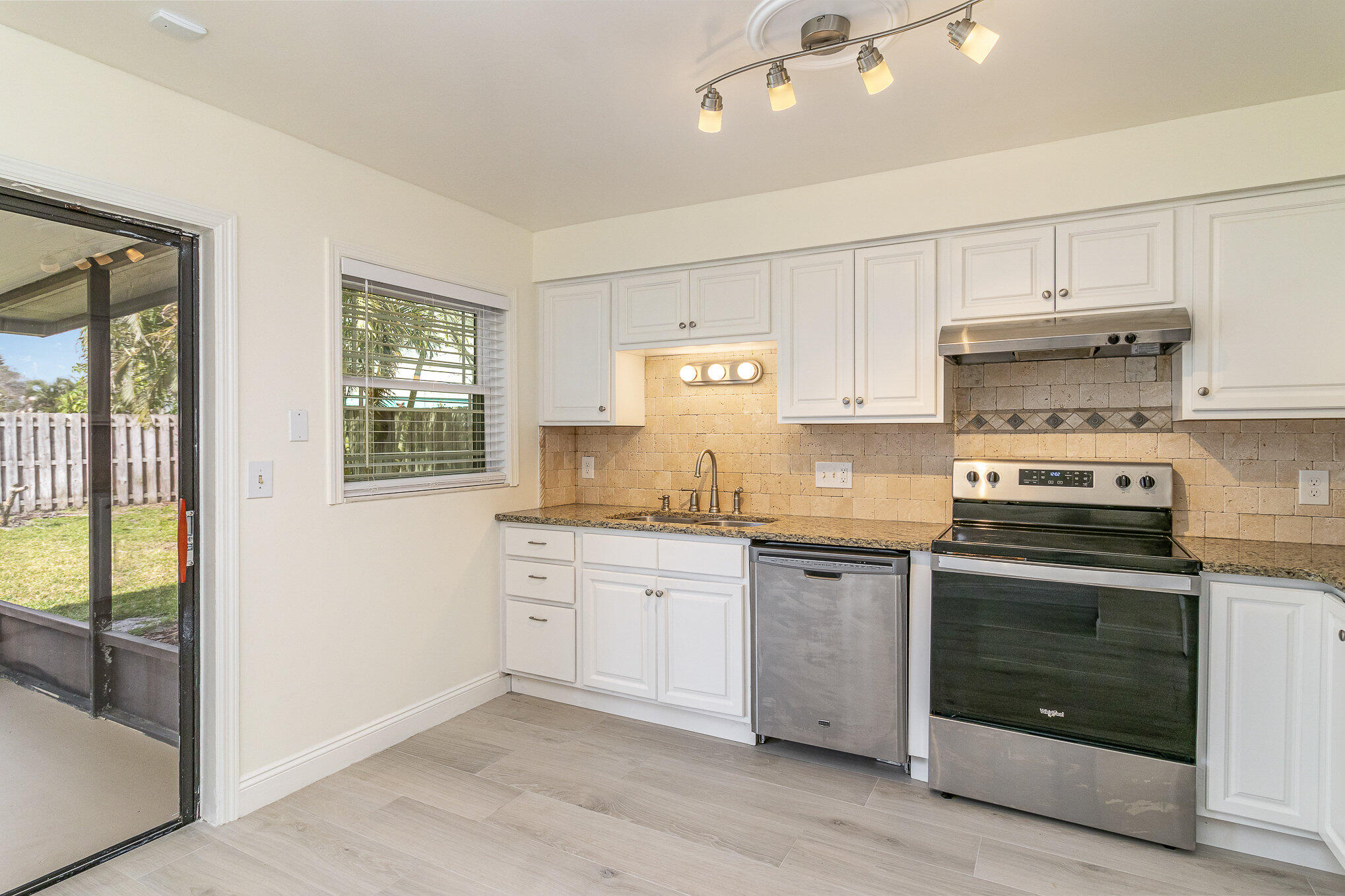 446 Timberlake Drive Melbourne, FL 32940 - Photo 5 of 20 a kitchen with stainless steel appliances granite countertop a stove and a sink