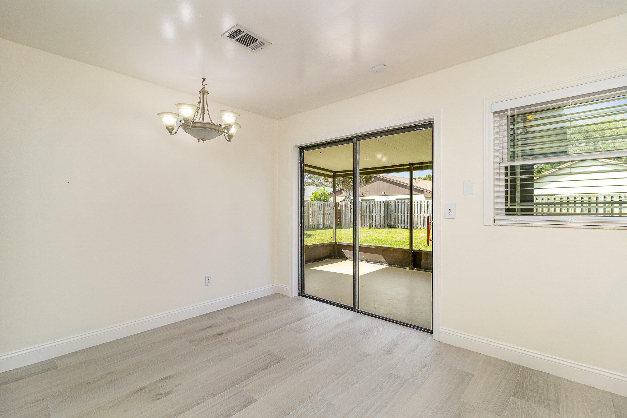 446 Timberlake Drive Melbourne, FL 32940 - Photo 6 of 20 an empty room with wooden floor and windows