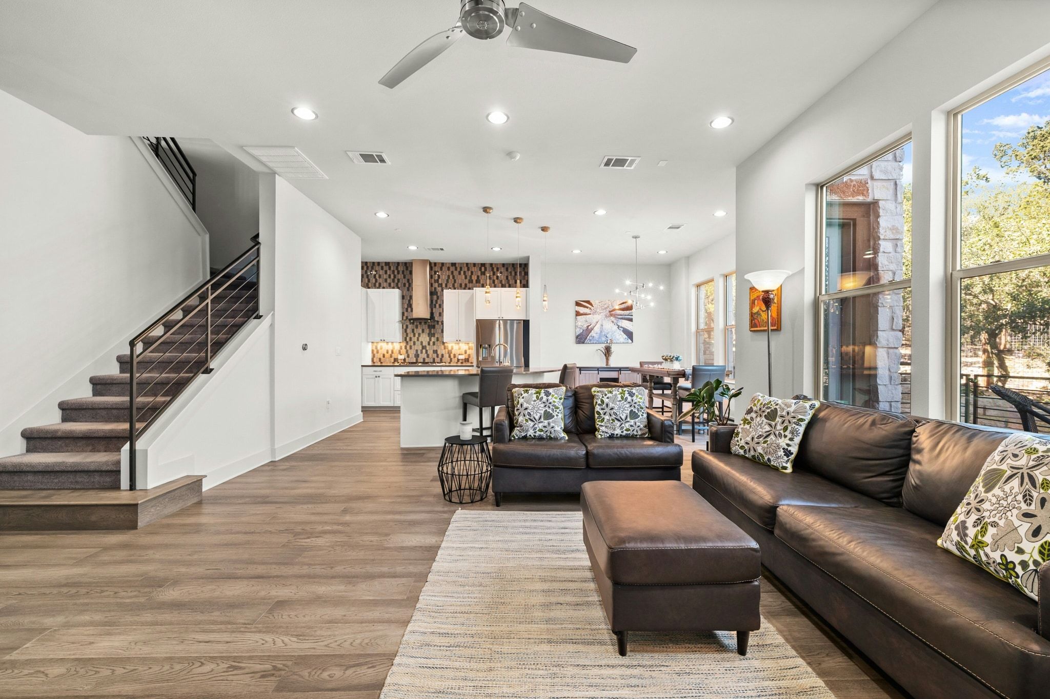 8110 Ranch Road 2222, Unit 92 Austin, TX 78730 - Photo 6 of 40 Open-concept living area featuring wood-finish flooring, recessed lighting, and a modern ceiling fan