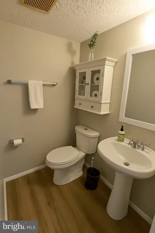 a bathroom with a sink toilet and mirror