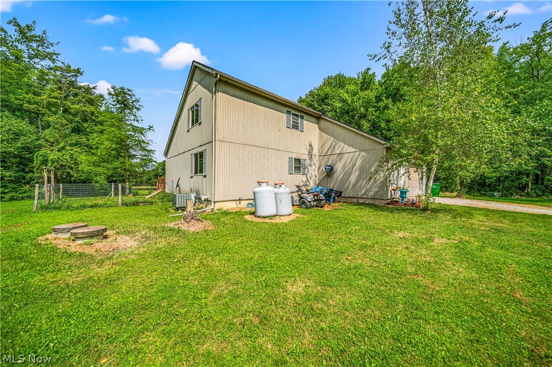 4460 Tower Road Dorset, OH 44032 - Photo 26 of 45 View of home's exterior with a yard and central AC
