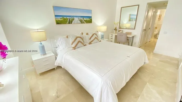 a spacious bedroom with a bed and a couch