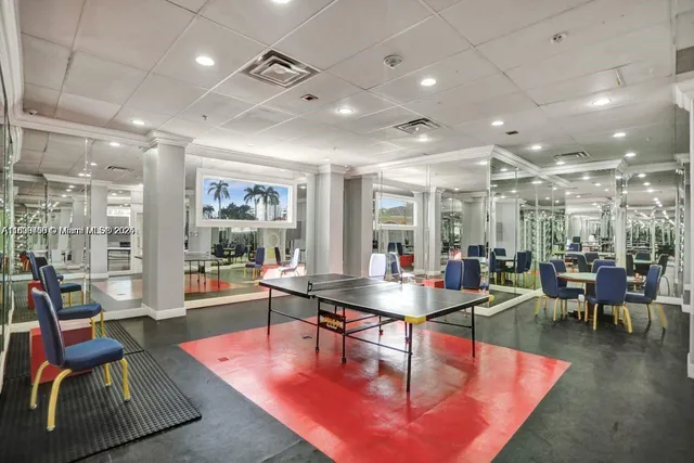 a dining room with lots of tables a large window and chairs