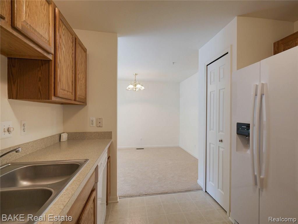 16954 Farmington Road, Unit 25 Livonia, MI 48154 - Photo 11 of 20 Kitchen with Pantry & Open to Dining Room