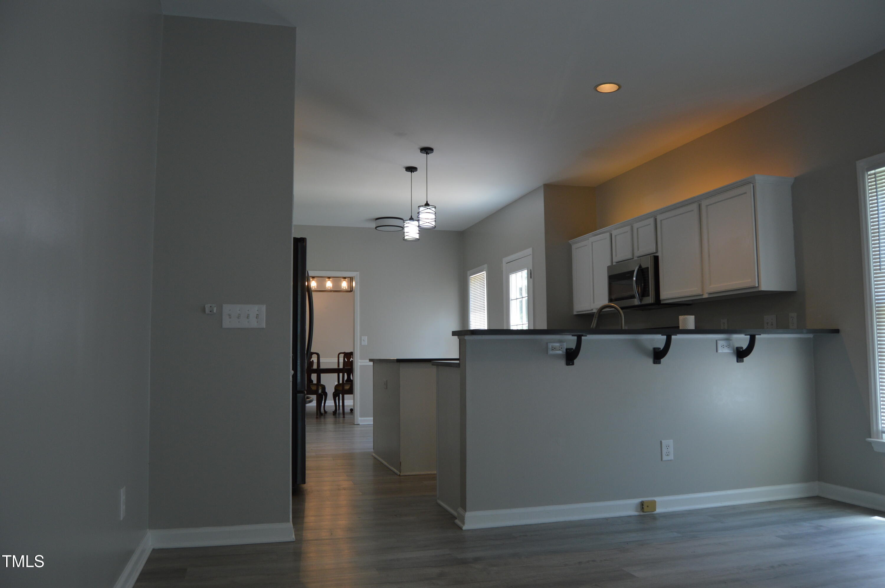 3401 Kensett Way Raleigh, NC 27616 - Photo 11 of 31 a view of a kitchen with furniture and wooden floor