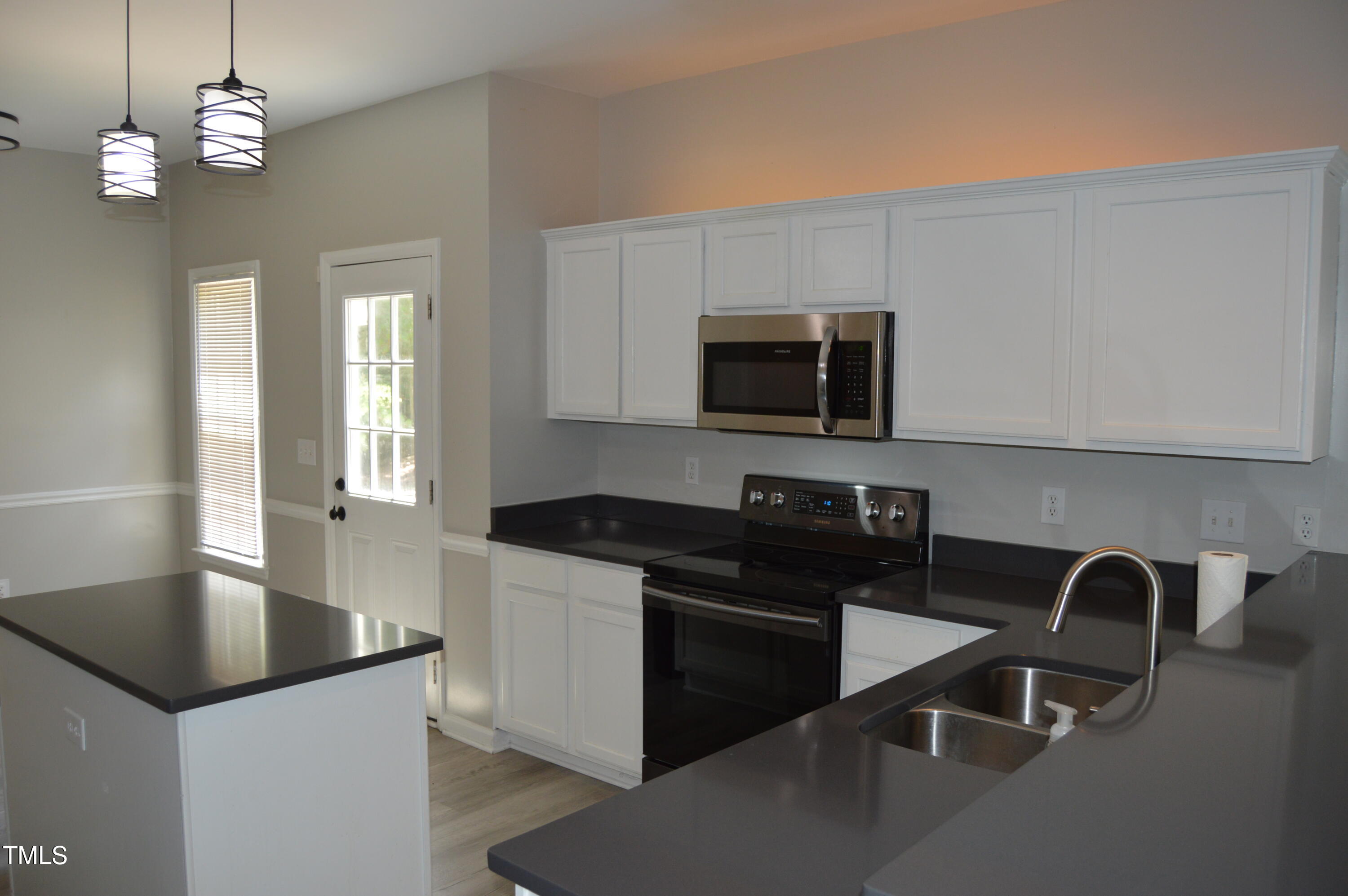3401 Kensett Way Raleigh, NC 27616 - Photo 12 of 31 a kitchen with granite countertop a sink a stove and microwave