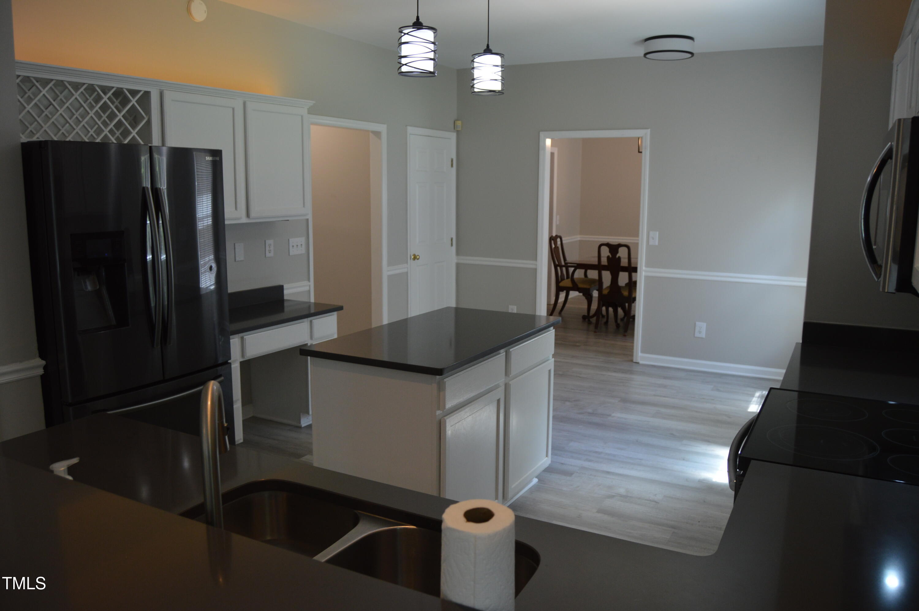 3401 Kensett Way Raleigh, NC 27616 - Photo 13 of 31 a kitchen with kitchen island a counter top space appliances and cabinets