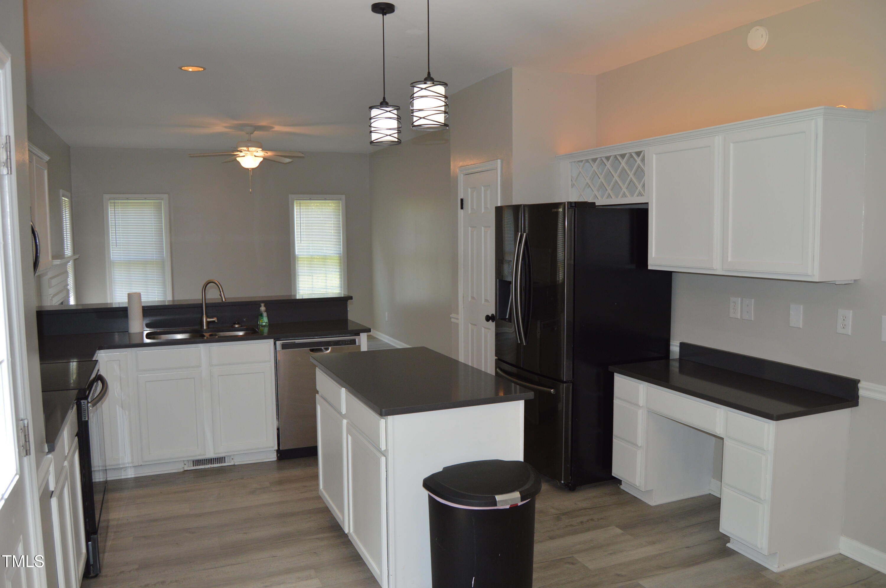 3401 Kensett Way Raleigh, NC 27616 - Photo 14 of 31 a kitchen with a refrigerator and a sink