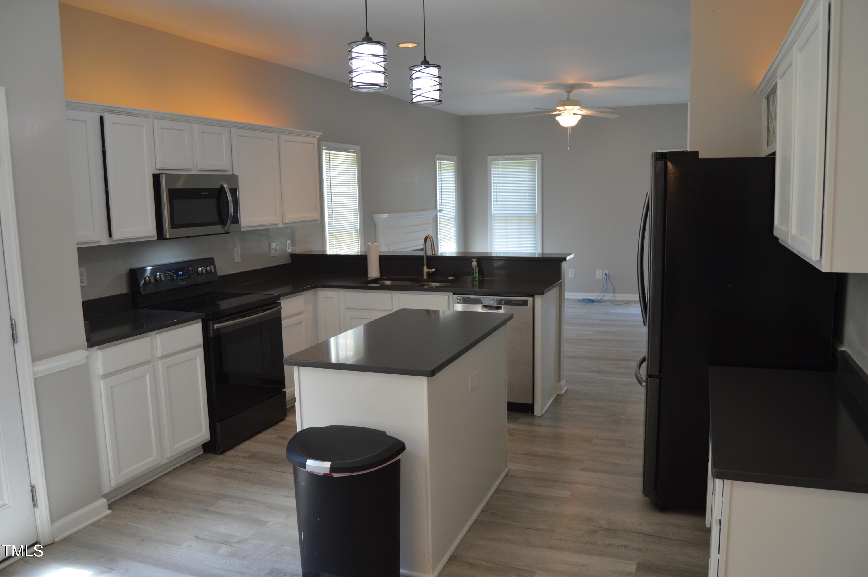 3401 Kensett Way Raleigh, NC 27616 - Photo 15 of 31 a kitchen with a sink a counter top space and stainless steel appliances