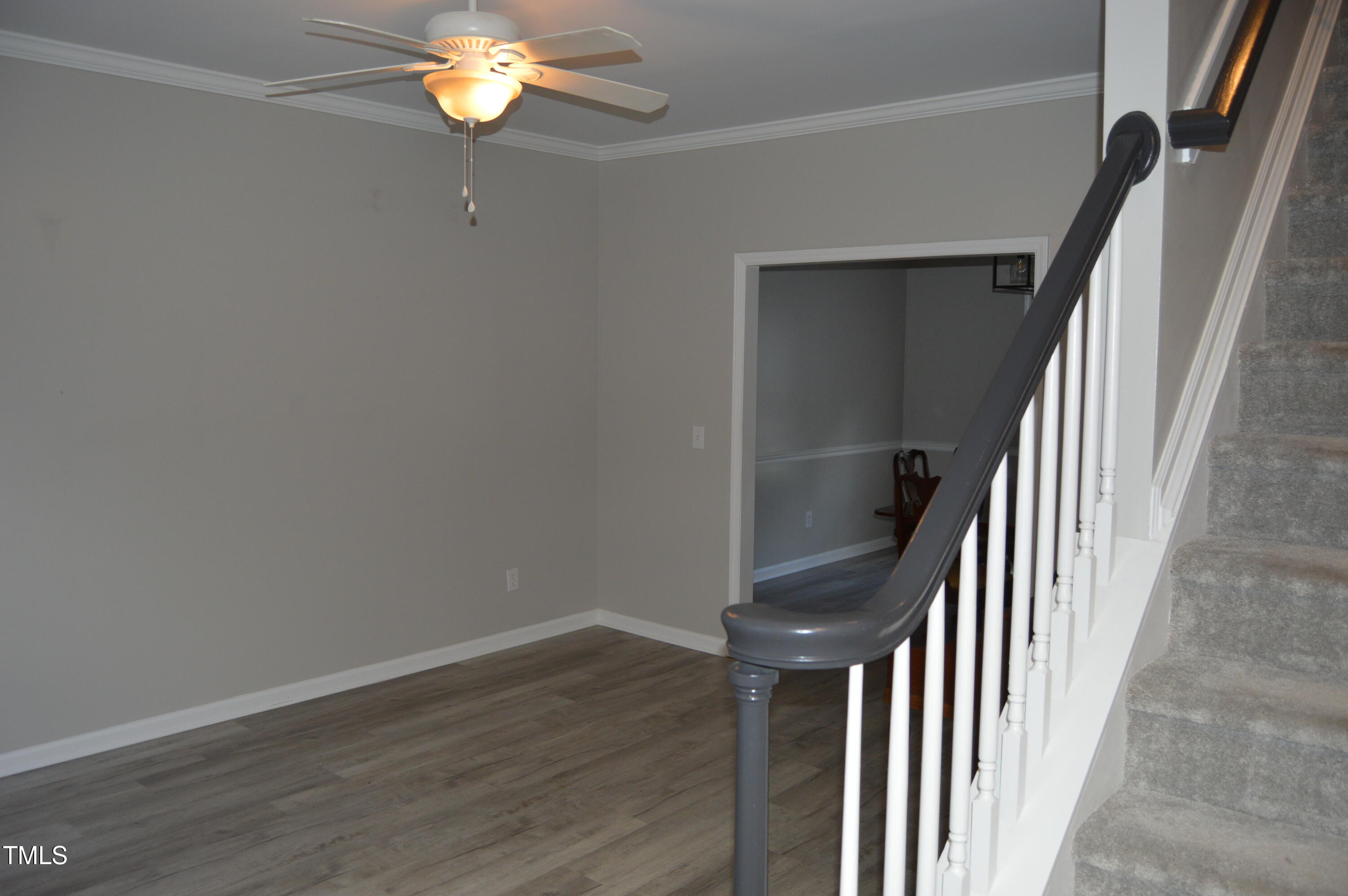3401 Kensett Way Raleigh, NC 27616 - Photo 7 of 31 wooden floor in an empty room with a chandelier fan