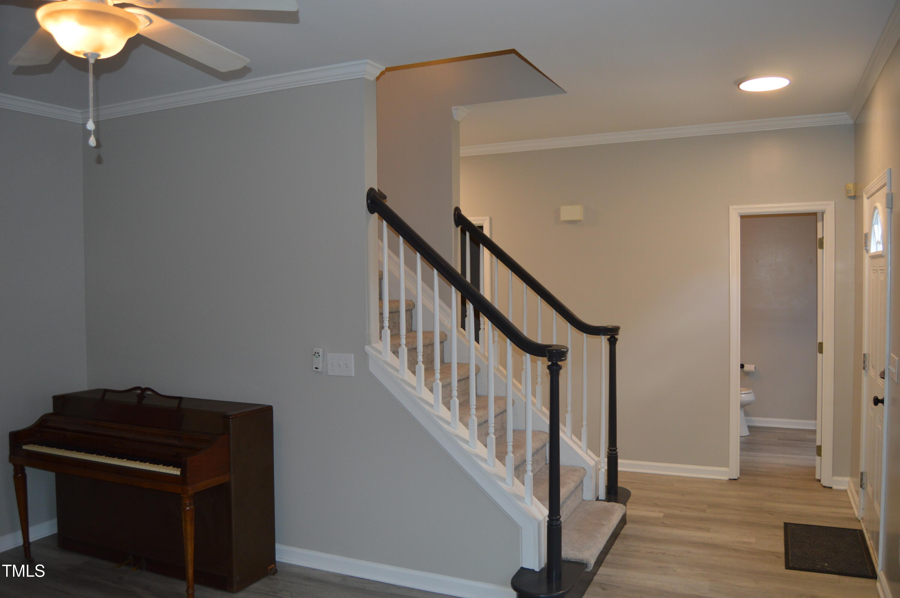 3401 Kensett Way Raleigh, NC 27616 - Photo 8 of 31 a view of a hallway with front door and wooden floor