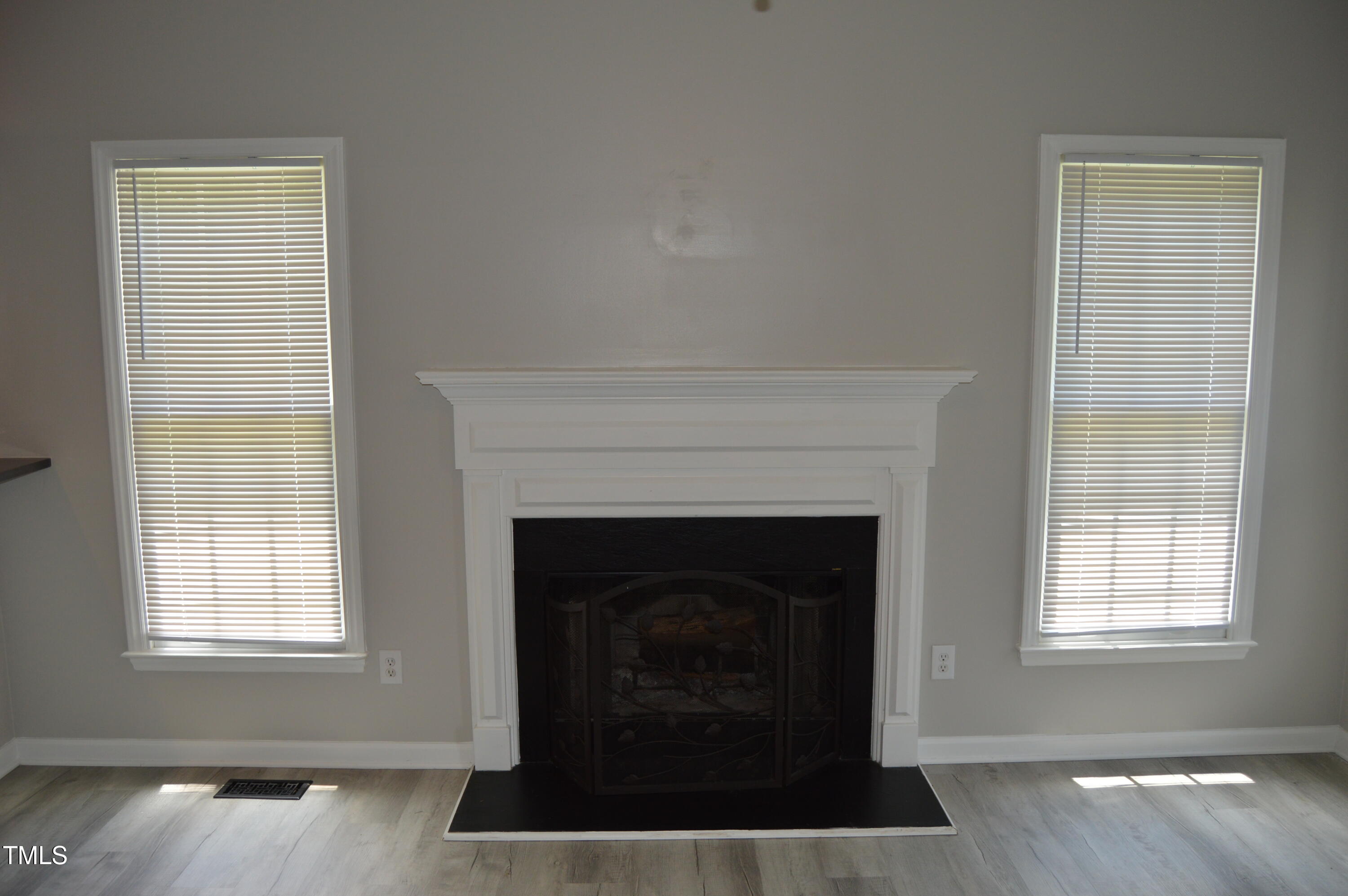 3401 Kensett Way Raleigh, NC 27616 - Photo 10 of 31 a living room with a fireplace and windows