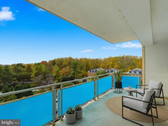 a view of a chairs and table in the balcony
