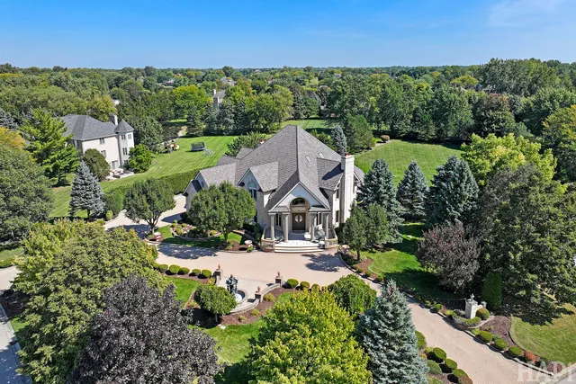 an aerial view of a house with a yard