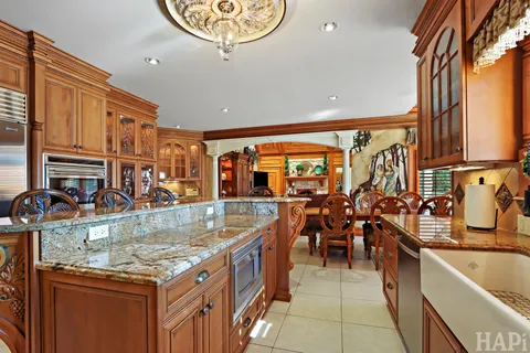 a living room with furniture a fireplace and a floor to ceiling window