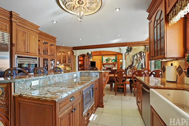 a living room with furniture a fireplace and a floor to ceiling window