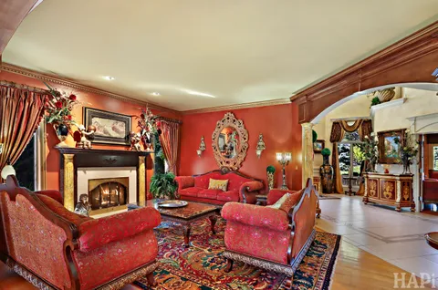 a bathroom with a granite countertop tub a sink and a large mirror next to a window