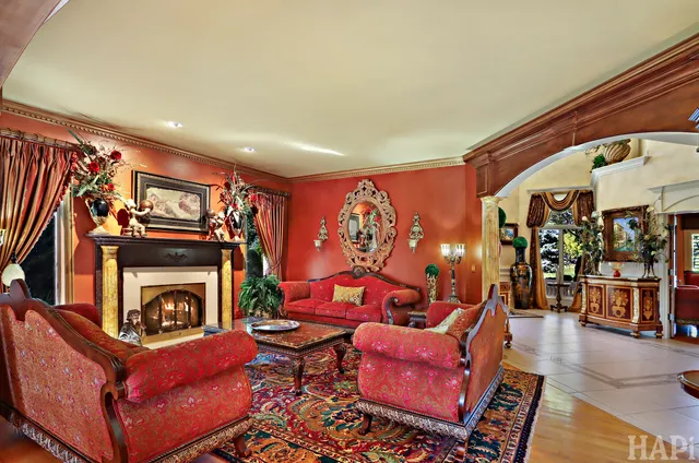 a bathroom with a granite countertop tub a sink and a large mirror next to a window