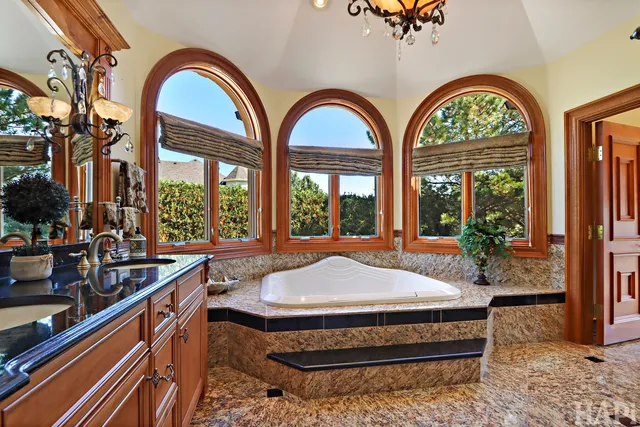 a bathroom with a sink mirror and a shower