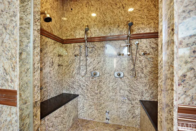 a bedroom with a bed dresser and wooden floor