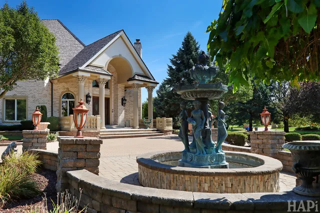 a view of a patio with table and chairs potted plants and palm tree