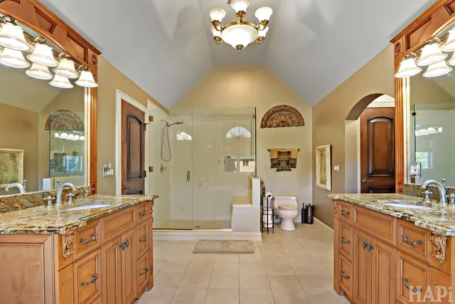 a kitchen with stainless steel appliances granite countertop wooden cabinets a sink and dishwasher a oven with wooden cabinets