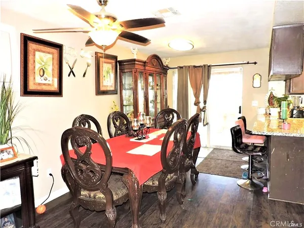 a view of a dining room with furniture and chandelier