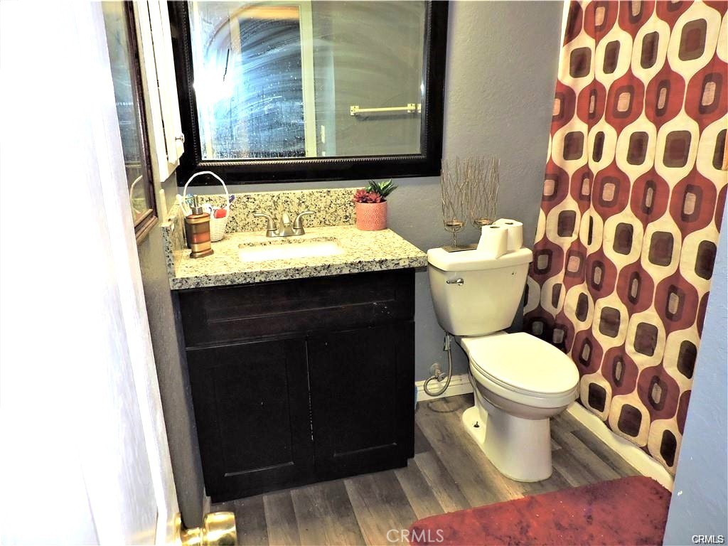 25659 Ash Road Barstow, CA 92311 - Photo 6 of 6 a bathroom with a granite countertop toilet and a sink