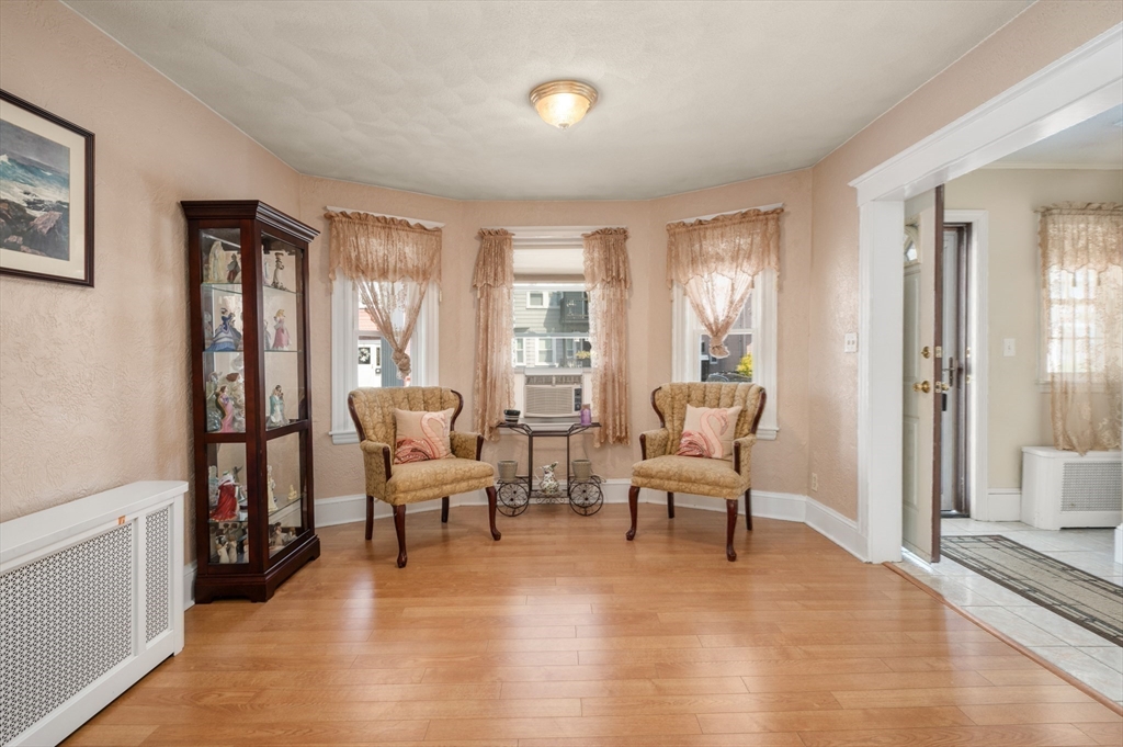 76 Windsor Road, Unit 1 Medford, MA 02155 - Photo 11 of 32 a living room with furniture and a large window