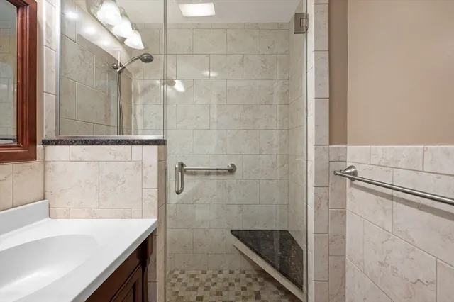 a bathroom with a shower and a sink