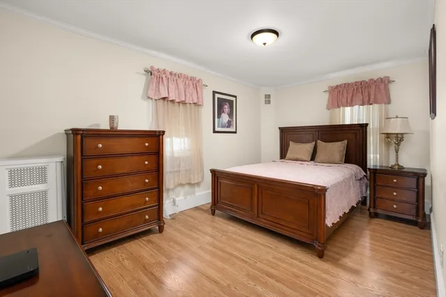 a bedroom with a bed and a dresser