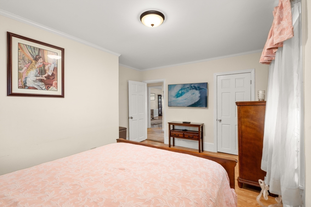 76 Windsor Road, Unit 1 Medford, MA 02155 - Photo 19 of 32 a bedroom with a bed and a desk