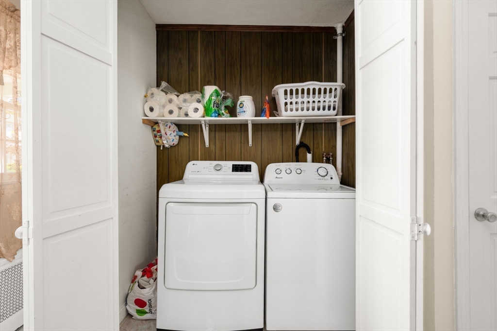 76 Windsor Road, Unit 1 Medford, MA 02155 - Photo 23 of 32 a view of storage and utility room with washer and dryer