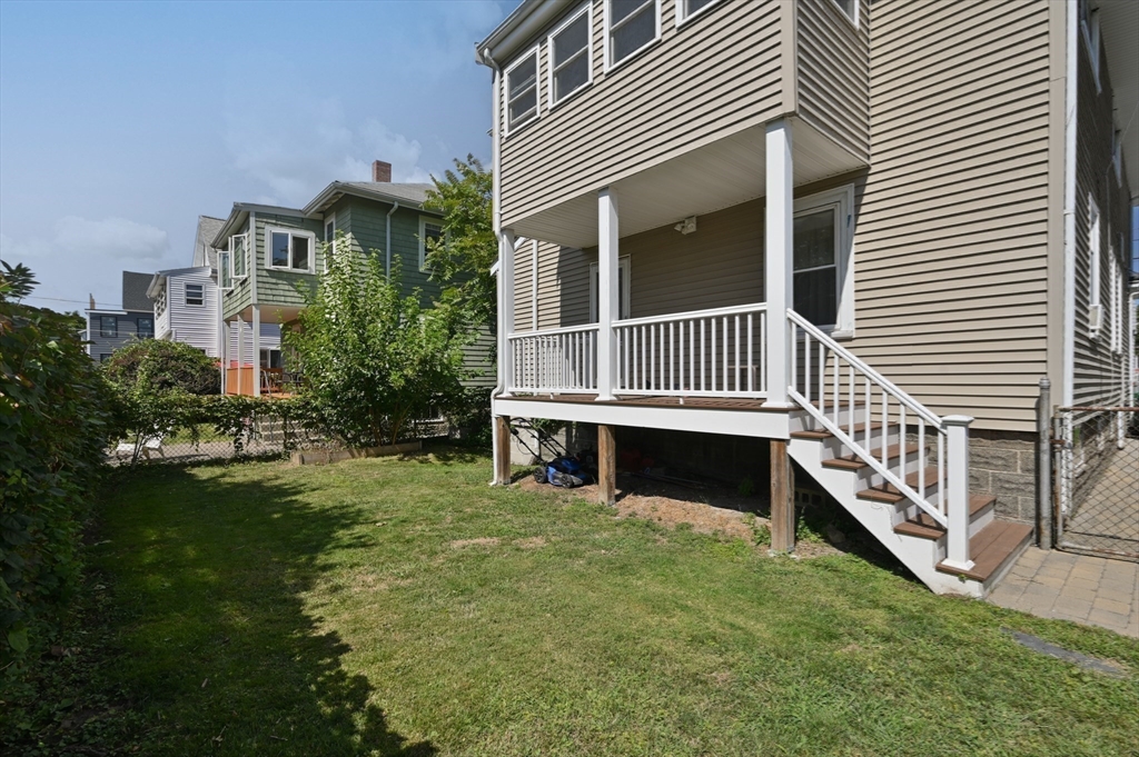 76 Windsor Road, Unit 1 Medford, MA 02155 - Photo 26 of 32 a view of a house with a yard and deck