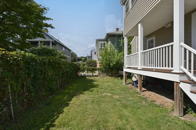 a backyard of a house with table and chairs