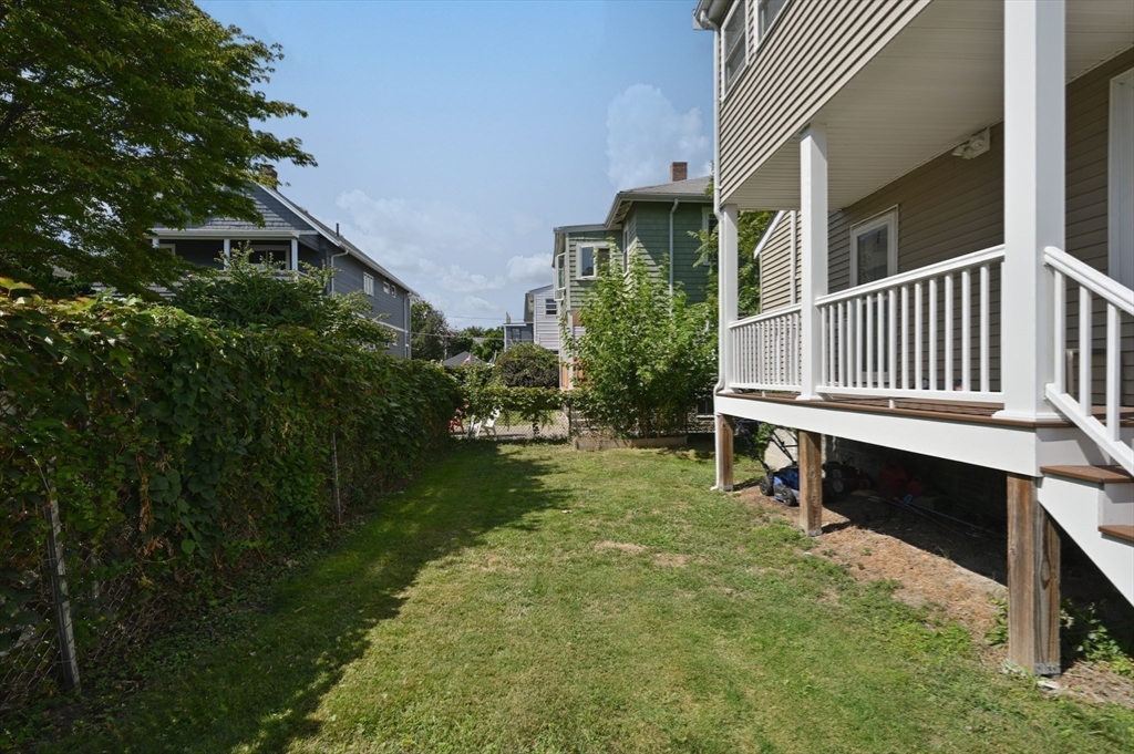 76 Windsor Road, Unit 1 Medford, MA 02155 - Photo 27 of 32 a backyard of a house with table and chairs