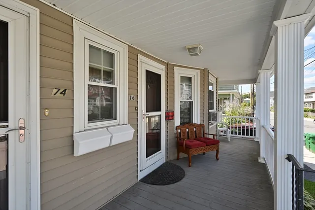 a view of a balcony with chairs and wooden floor