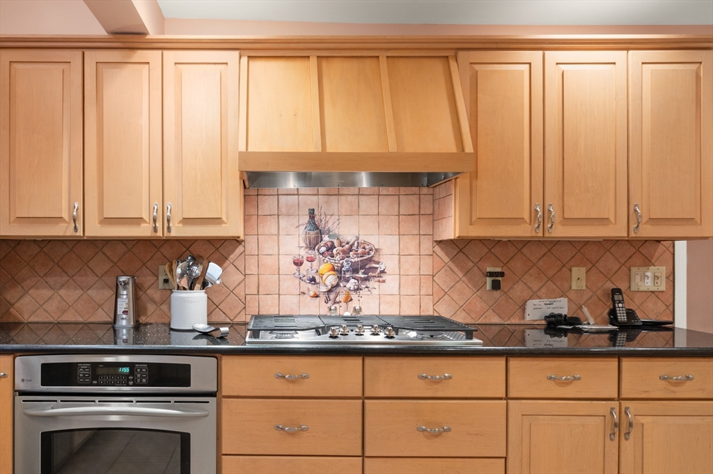 76 Windsor Road, Unit 1 Medford, MA 02155 - Photo 6 of 32 a kitchen with stainless steel appliances granite countertop a sink and a white cabinets