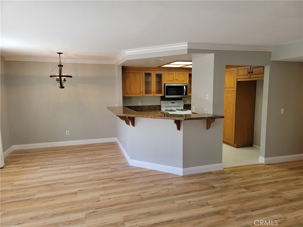 941 Lotus Circle San Dimas, CA 91773 - Photo 13 of 25 a view of a kitchen with wooden floor and electronic appliances