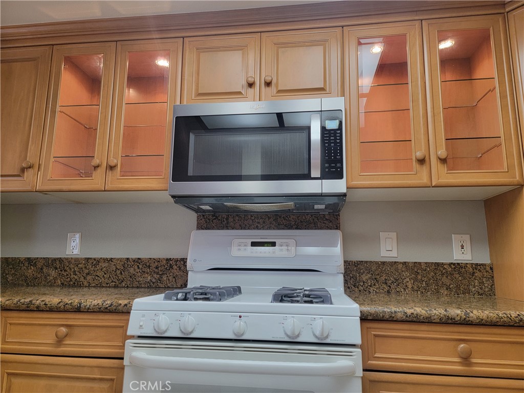 941 Lotus Circle San Dimas, CA 91773 - Photo 15 of 25 a kitchen with stainless steel appliances granite countertop a stove and a microwave