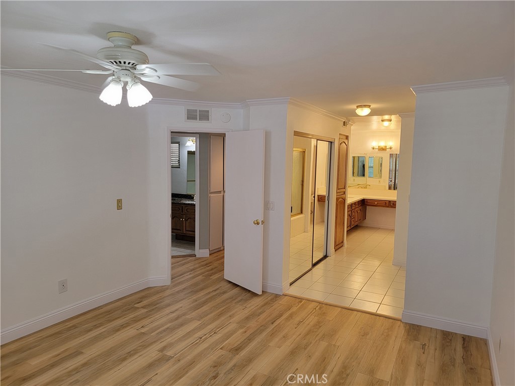 941 Lotus Circle San Dimas, CA 91773 - Photo 16 of 25 a view of a hallway with wooden floor and a chandelier