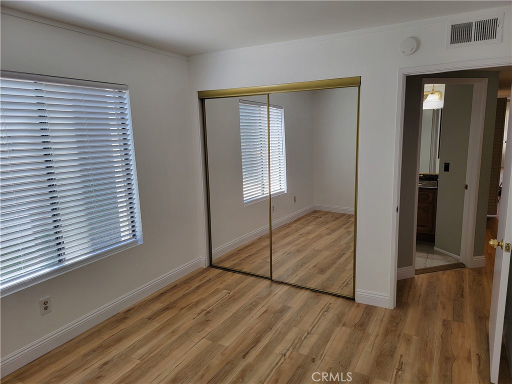 941 Lotus Circle San Dimas, CA 91773 - Photo 21 of 25 a view of an empty room with wooden floor and a window