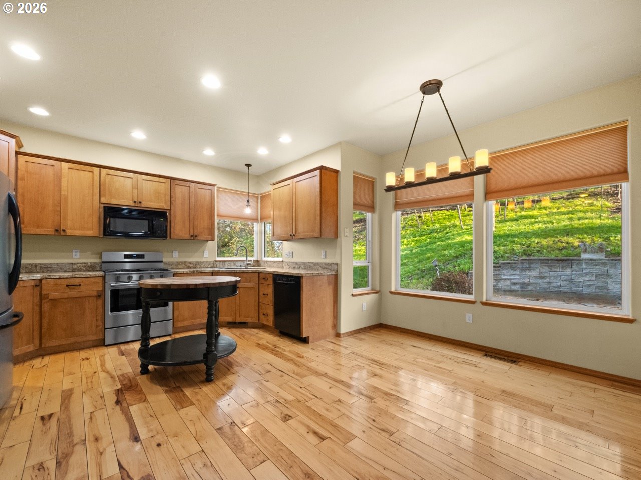 1101 B Avenue La Grande, OR 97850 - Photo 7 of 35 a kitchen with stainless steel appliances granite countertop a stove and a wooden floors