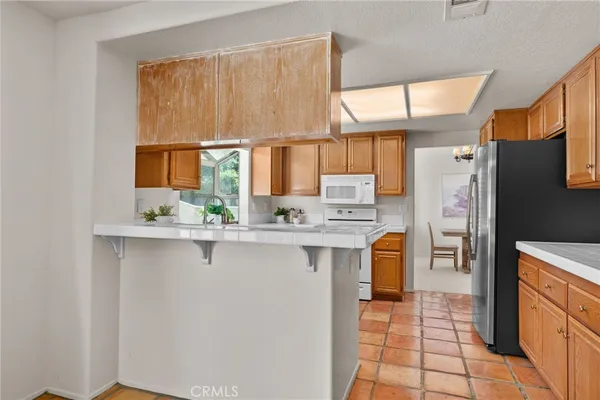 a kitchen with stainless steel appliances a refrigerator sink and cabinets