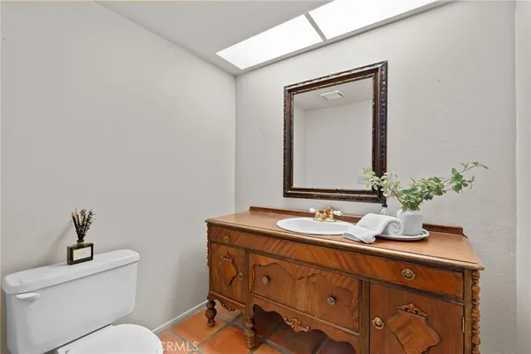 a bathroom with a toilet a sink and mirror