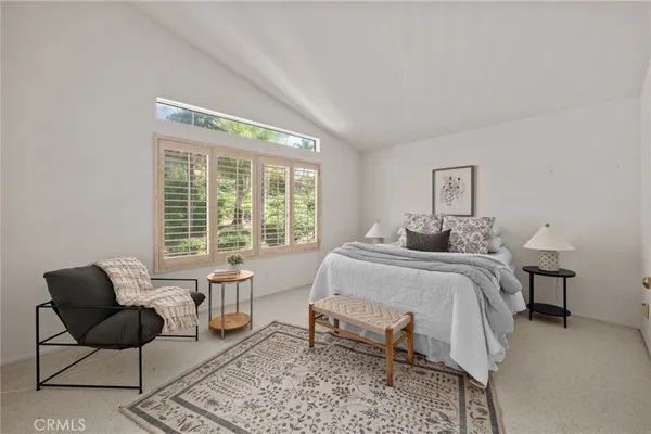 a bedroom with a bed and a couch