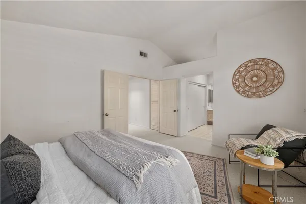 a bedroom with a bed and chair