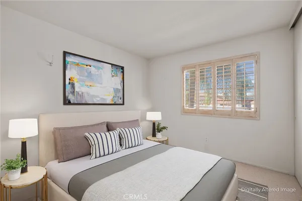 a bedroom with a bed and a painting on the wall