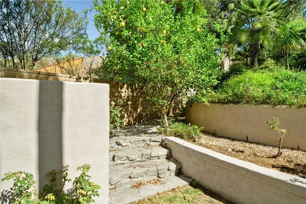 a front view of a house with a yard and potted plants
